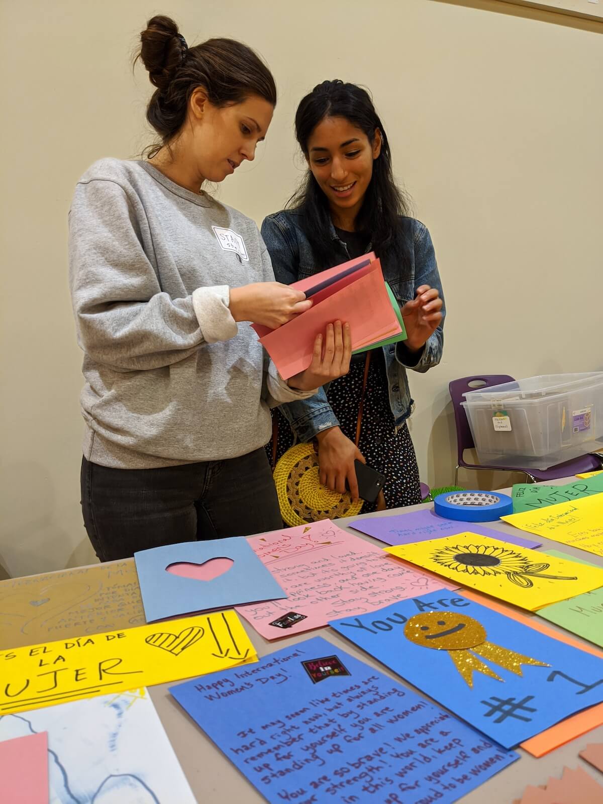 Volunteers organizing cards during women's international day .